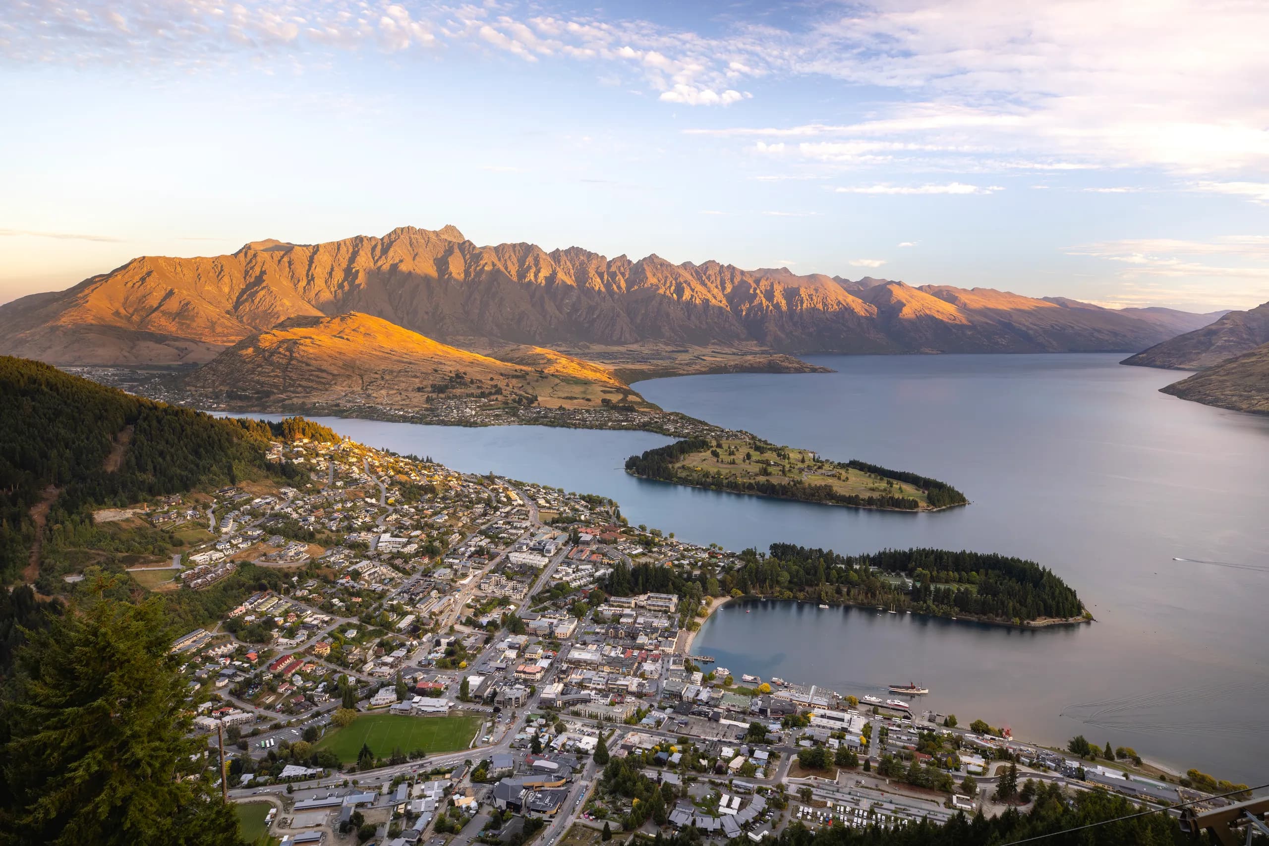 Queenstown from above in summer, the town, the peninsula and the lake in late afternoon light